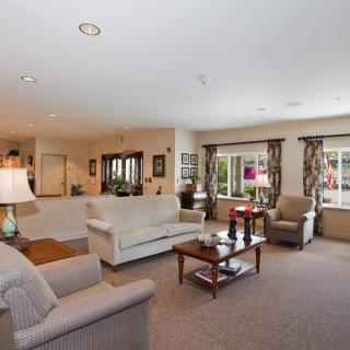 A spacious and well-decorated living room with comfortable seating and natural light.