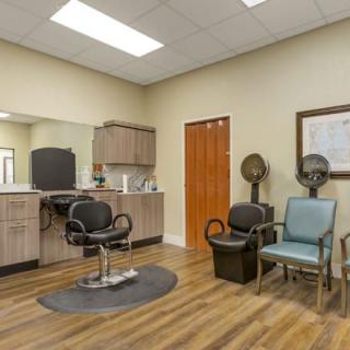 A modern salon interior with hairdressing chairs and equipment.
