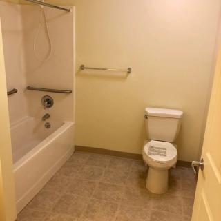 A small bathroom with a bathtub and toilet.