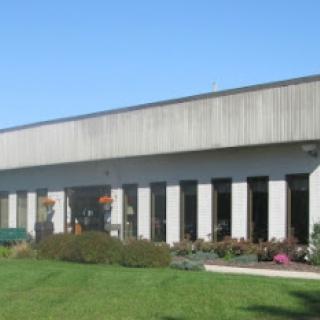 A modern commercial building with a landscaped garden.