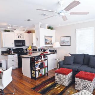A cozy open-concept living space with a modern kitchen and comfortable seating area.