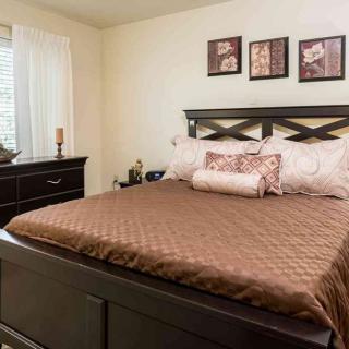 A cozy bedroom with a neatly made bed and stylish decor.
