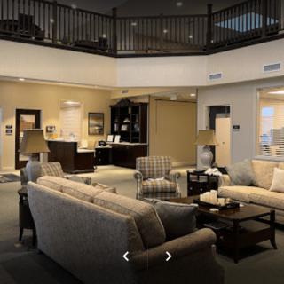 A spacious and elegantly designed living room with comfortable sofas and a coffee table.