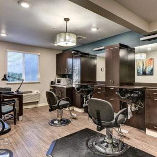 Modern hair salon interior with multiple workstations and stylish decor.