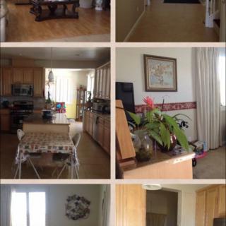 A cozy home interior showcasing a kitchen and living room area, complete with furniture and decorative elements.