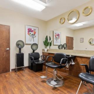 A modern hair salon interior with styling chairs and mirrors.