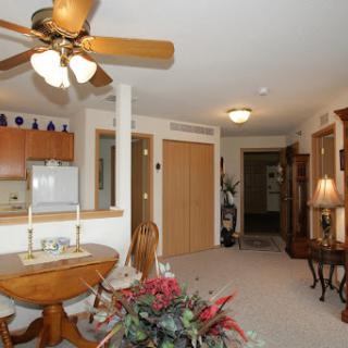 A cozy living room featuring a ceiling fan and elegant decor.