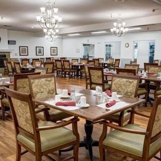 An empty dining room with neatly set tables and chairs.