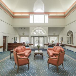 A spacious lobby with comfortable seating and large windows allowing natural light to fill the room.