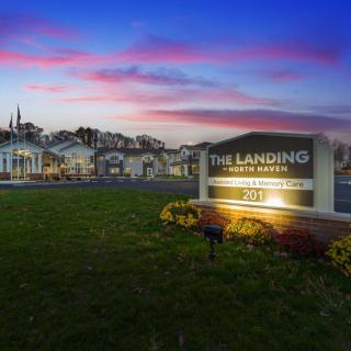 An apartment complex with a prominent sign at sunset.