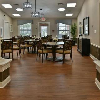A spacious dining area with elegant decor and wooden flooring.