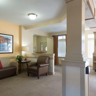 A cozy living room with comfortable seating and warm lighting.