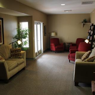 A cozy living room featuring comfortable seating and natural light.