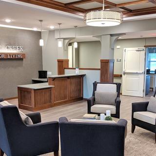 A modern lobby with comfortable seating and a reception desk.
