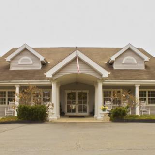 A symmetrical building with a central entrance and prominent columns.
