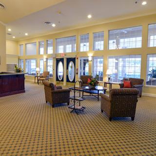 A spacious lobby with comfortable seating and large windows.