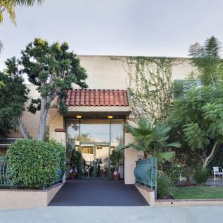 Entrance to a building surrounded by lush greenery.