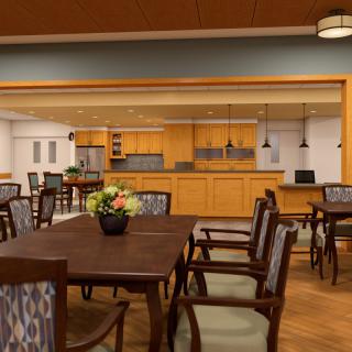 A modern dining area with a view of an open kitchen.