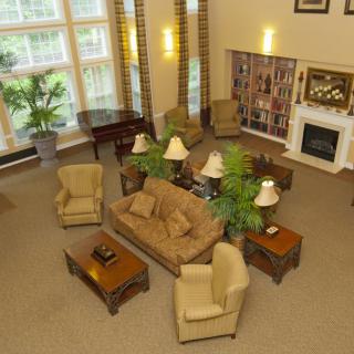 A spacious living room with comfortable seating, a fireplace, and large windows.