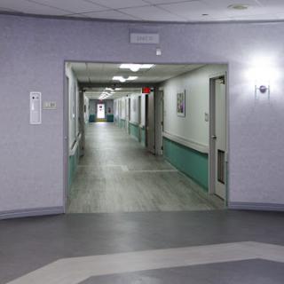 A view of a hospital corridor, illustrating the clean and sterile environment typical in healthcare facilities.