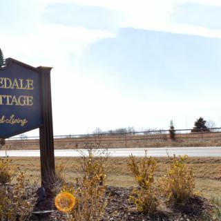 A roadside sign in a rural landscape on a sunny day.