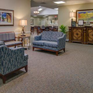 An inviting reception area with comfortable seating and artwork on the walls.
