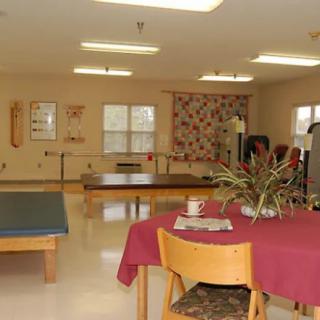 A rehabilitation therapy room equipped with exercise furniture and equipment.