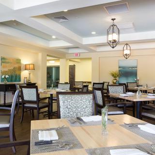 An elegant restaurant dining area with well-arranged tables and comfortable chairs.