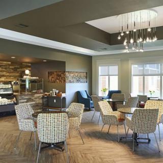 A modern and comfortable cafe interior with stylish seating and warm lighting.