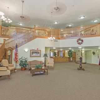 Spacious lobby with comfortable seating and a grand staircase.