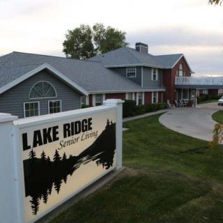 A view of the Lake Ridge Senior Living entrance with signage and surrounding landscape.