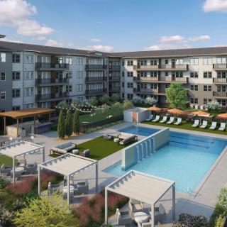 A modern apartment complex featuring an outdoor pool with lounge chairs, pergolas, and well-maintained landscaping.