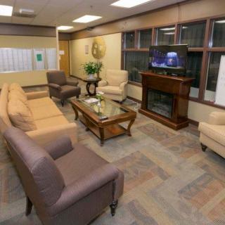 A cozy living room with sofas, a coffee table, and a fireplace along with a television.