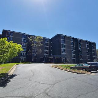 A modern apartment building captured under a clear blue sky.