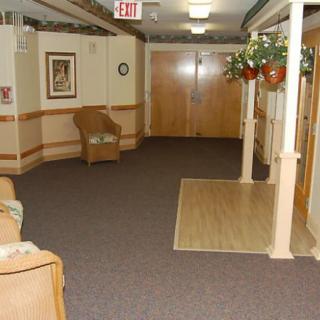An interior view of a hallway with chairs and decorative elements.