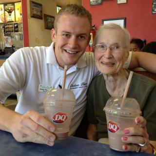 Two people enjoying milkshakes together at a Dairy Queen.