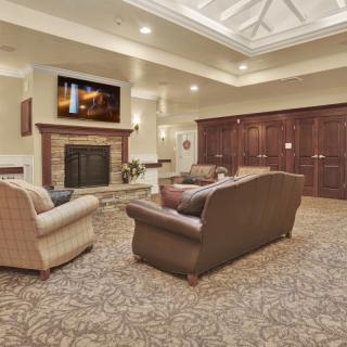 A cozy living room with a fireplace and seating area.