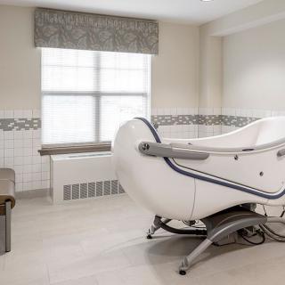 A modern and accessible bathtub in a well-lit bathroom.