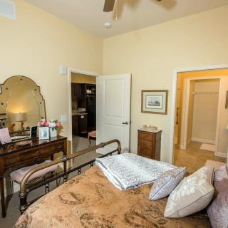 A cozy bedroom with a metal bed frame and a vintage vanity set.