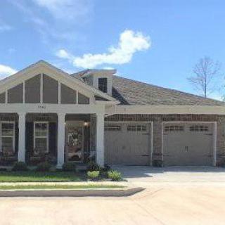 A suburban residential house with a two-car garage and a driveway.