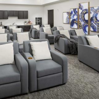 A modern lounge area with comfortable seating and contemporary artwork.
