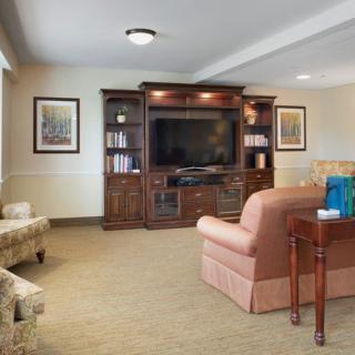 A cozy living room with a large entertainment center and comfortable seating.