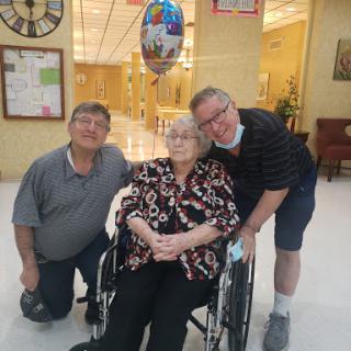 A heartwarming moment with family, celebrating together in a care facility.
