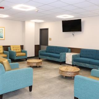 A modern lounge area featuring comfortable seating and a television, designed for relaxation and socializing.