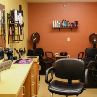 A cozy hair salon interior with professional equipment and styling products.