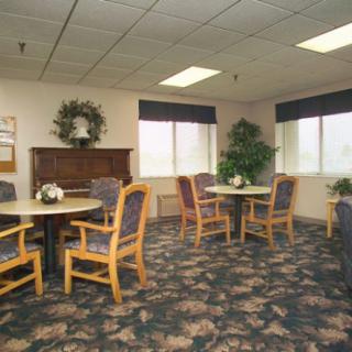A cozy meeting room with tables, chairs, and decorative elements.