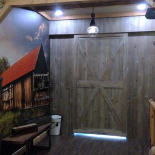 A rustic wooden door with barn-style decor and ambient lighting.