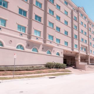 A multi-story building with a symmetrical facade and several windows.