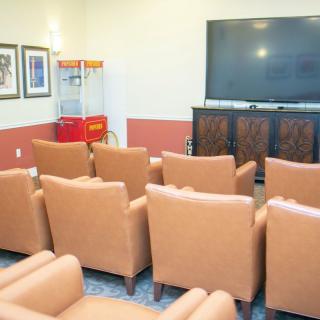 A cozy home theater setup with comfortable seating and a popcorn machine.
