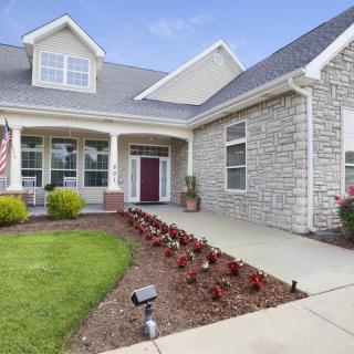 A charming house with a well-maintained front yard and garden bed.